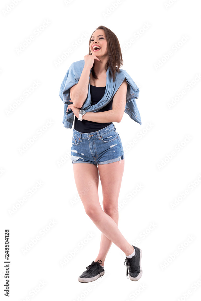 Entertained beautiful female audience looking away and laughing. Full body isolated on white background. Entertained beautiful female audience looking away and laughing. Full body isolated on white background.