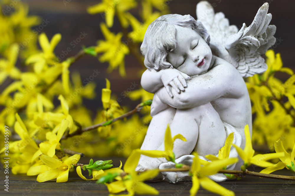 Guardian angel and yellow forsythia flowers Guardian angel and yellow forsythia flowers