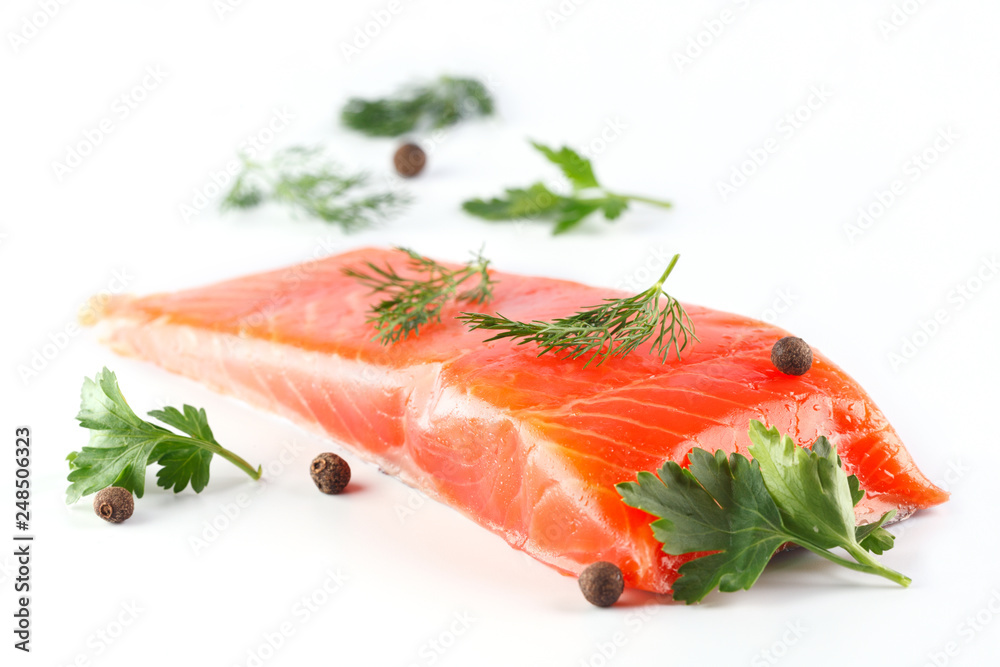salmon with herbs and spices on white background