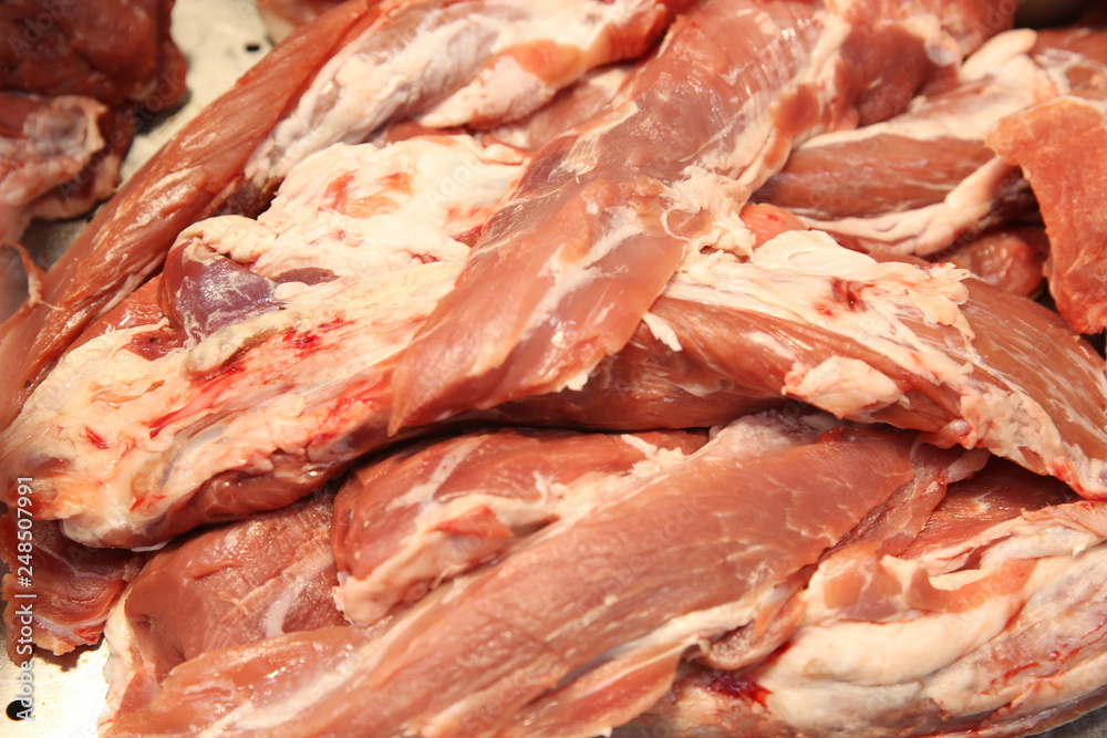 fresh raw pork meat cut into pieces on the market