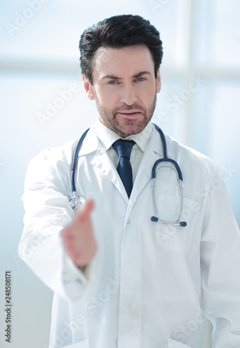 background image of the doctor holding out his hand for greeting