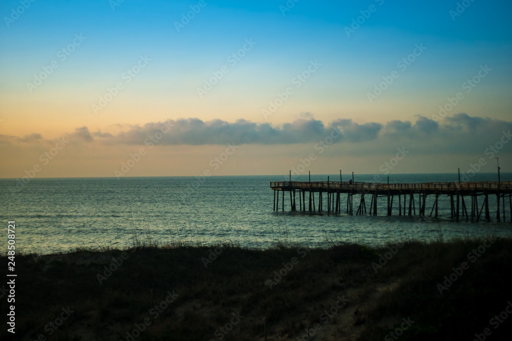 Fototapeta premium pier and ocean at sunrise