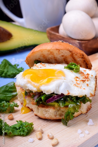 Sandwich with fried egg and salad with kale