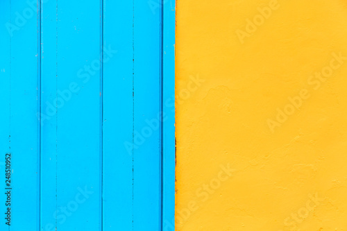 Pastel blue wooden and yellow wall background. Architecture details on Havana, Cuba.