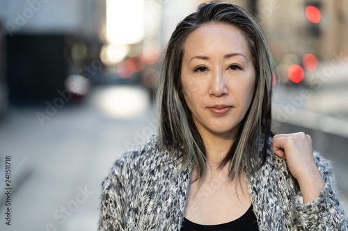 Obraz na plátně Asian woman in city serious face portrait