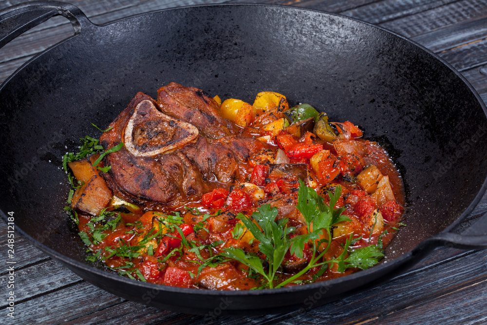 juicy, fried, tender steak with vegetables and sauces on a special stand juicy, fried, tender steak with vegetables and sauces on a special stand