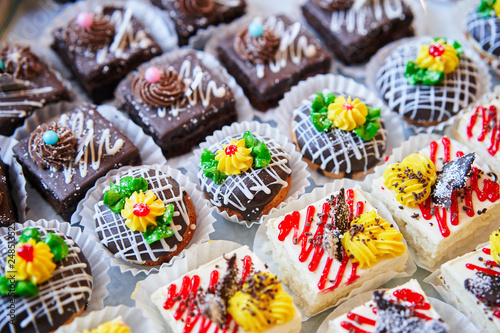 Assortment of pieces of cake on table, copy space. Several slices of delicious desserts, restaurant menu concept photo