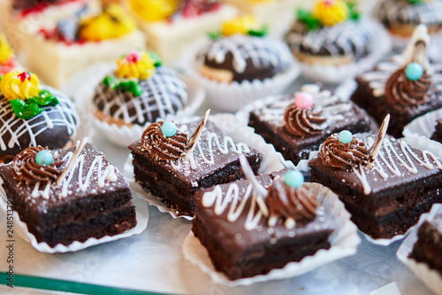 Assortment of pieces of cake on table, copy space. Several slices of delicious desserts, restaurant menu concept