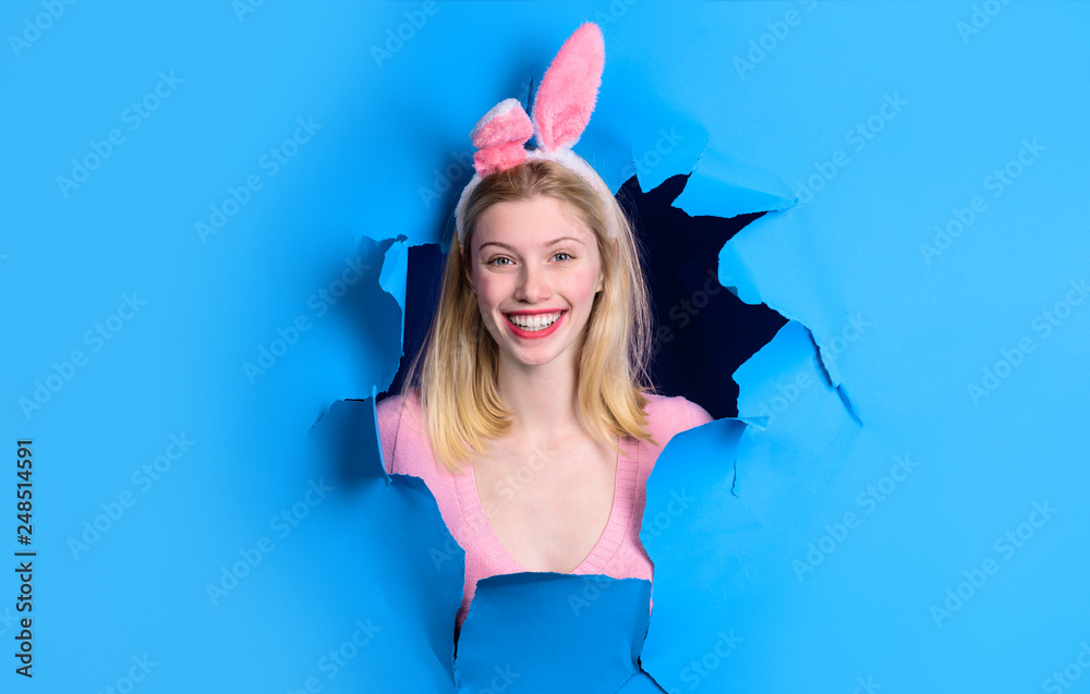 Woman through paper. Happy easter! Bunny ears. Happy woman looking through paper. Egg hunt. Easter. Bunny. Easter hunt. Bunny ears. Breaking paper. Easter Sale. Discount.