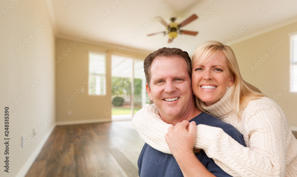 Happy Caucasian Young Adult Couple In Empty Room of House Happy Caucasian Young Adult Couple In Empty Room of House