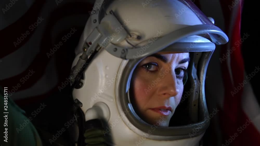 Close up shot of astronaut woman with the helmet visor up relaxing and breathing deep Close up shot of astronaut woman with the helmet visor up relaxing and breathing deep