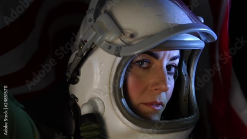 Close up shot of astronaut woman with the helmet visor up relaxing and breathing deep