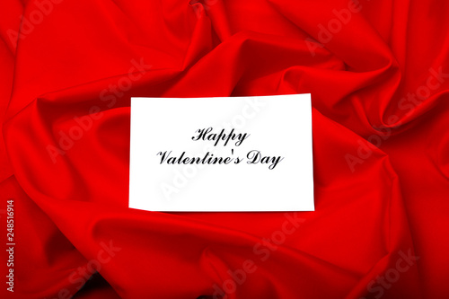 Valentine's day background with greeting card on red.