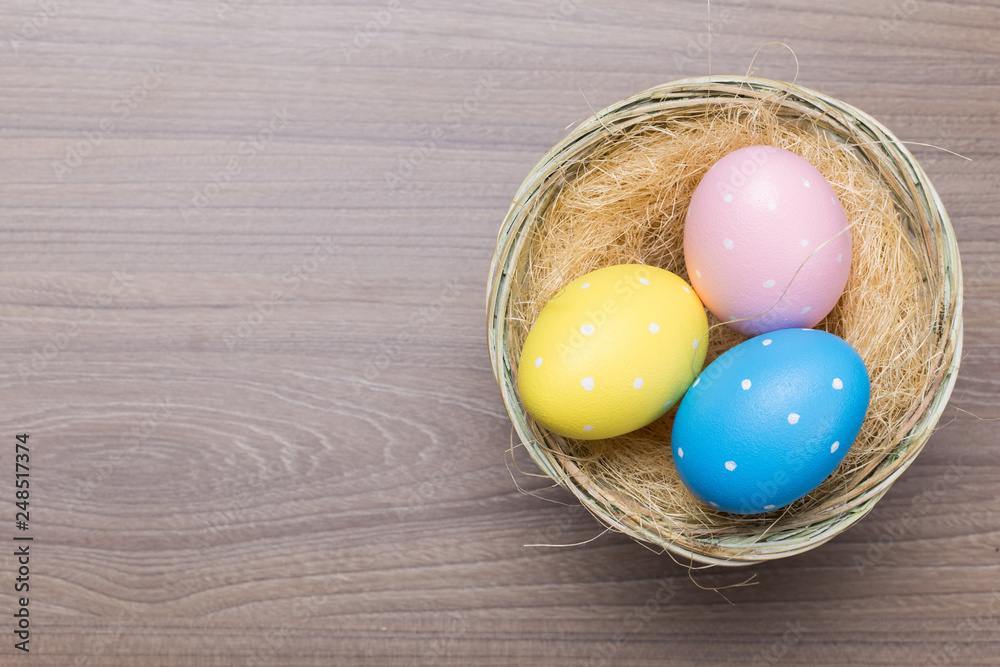 Easter eggs in the basket on wooden background Easter eggs in the basket on wooden background