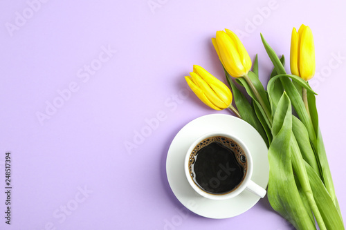 Beautiful bouquet of yellow tulips on color background, top view. Space for text