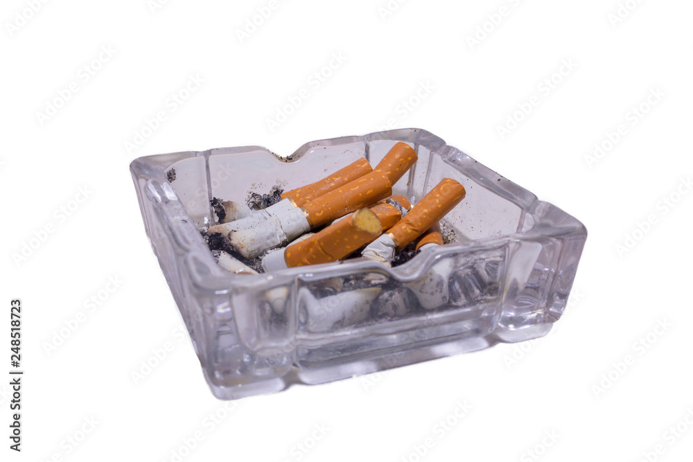 Glass ashtray with cigarettes on a white isolated background Glass ashtray with cigarettes on a white isolated background