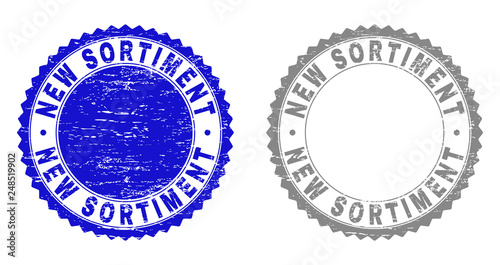 Grunge NEW SORTIMENT stamp seals isolated on a white background. Rosette seals with grunge texture in blue and grey colors. Vector rubber stamp imitation of NEW SORTIMENT label inside round rosette.
