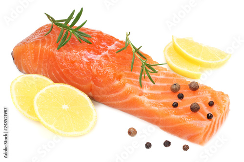 Red fish. Raw salmon fillet with rosemary and lemon isolate on white background.