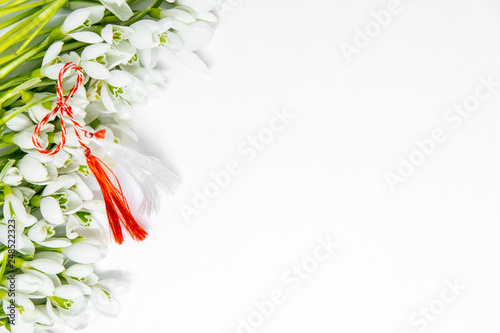 snowdrops flowers arranged on white background with copy space and first of march romanian bulgarian symbolic tradition  photo