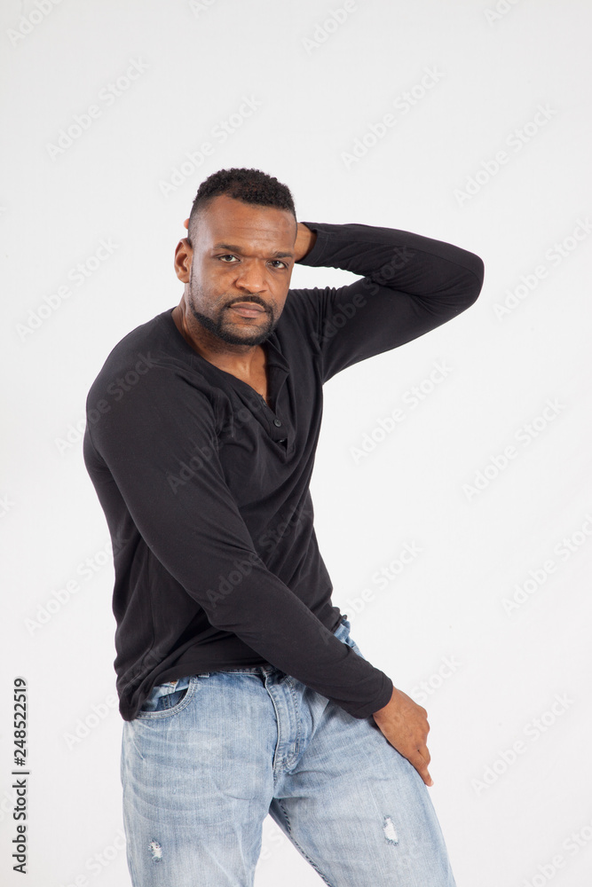 Fototapeta premium Thoughtful Black man in a black shirt and jeans