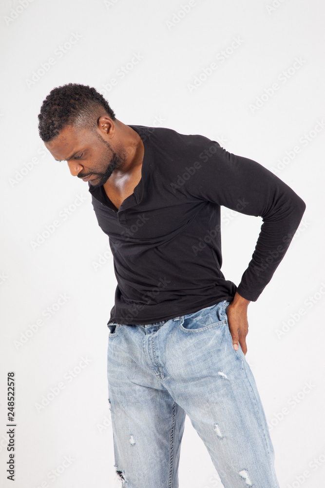 Fototapeta premium Thoughtful Black man in a black shirt and jeans