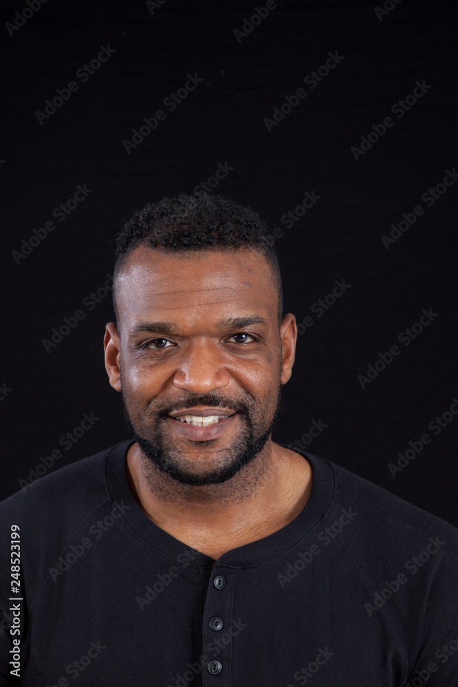 Smiling Black man in black shirt