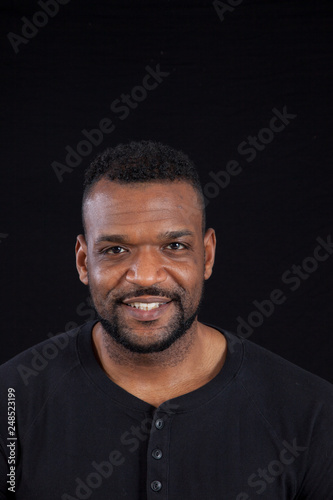 Smiling Black man in black shirt