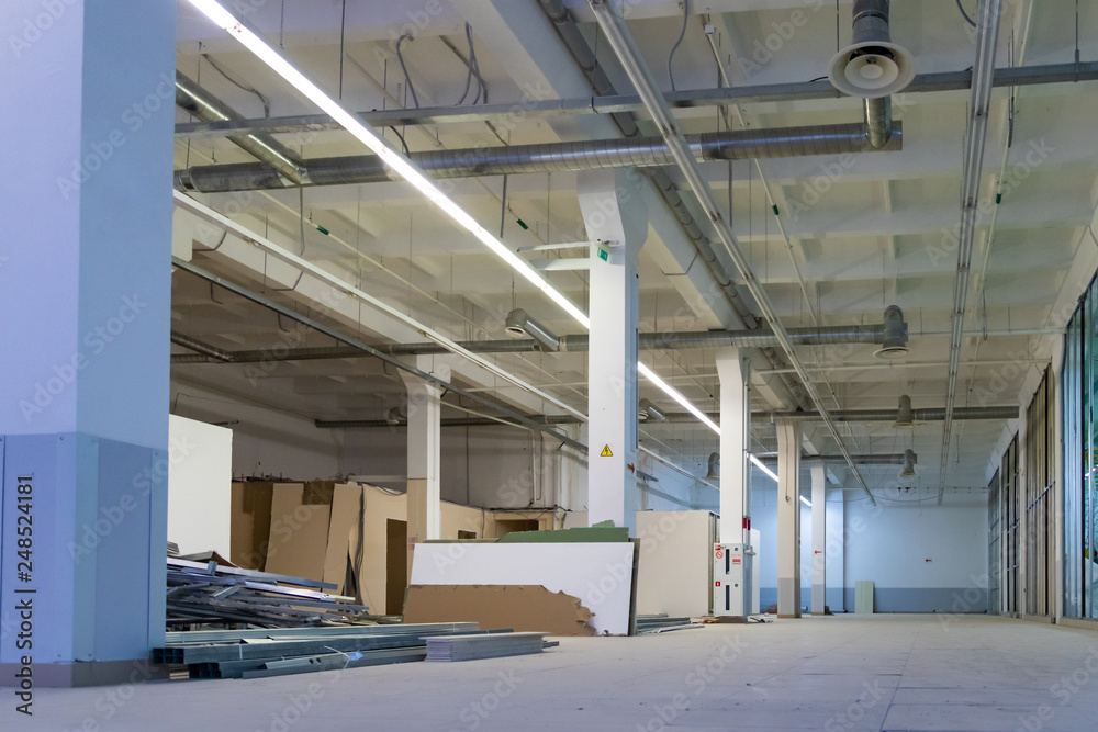 Shutter door or roller door and concrete floor inside factory building for industry background. Shutter door or roller door and concrete floor inside factory building for industry background.