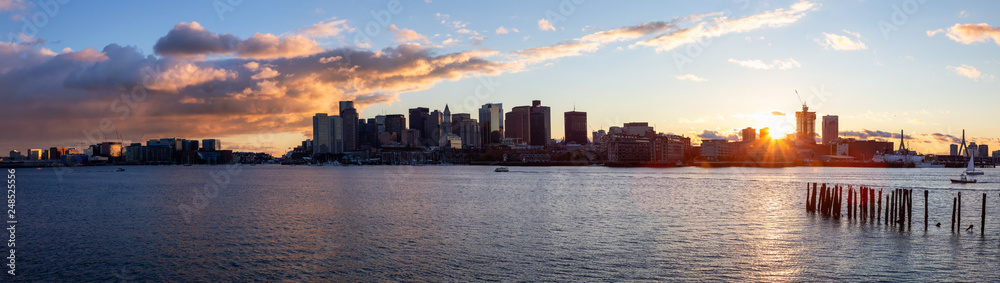 Striking panoramic cityscape of a modern Downtown City during a vibrant sunset. Taken from LoPresti Park, Boston, Capital of Massachusetts, United States.