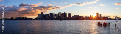 Striking panoramic cityscape of a modern Downtown City during a vibrant sunset. Taken from LoPresti Park, Boston, Capital of Massachusetts, United States. © edb3_16