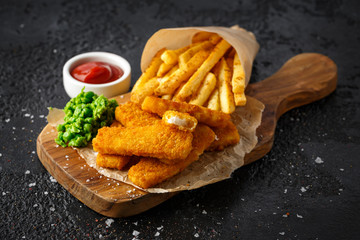 Fish fingers, mashed peas and chips fries. Traditional British fast food