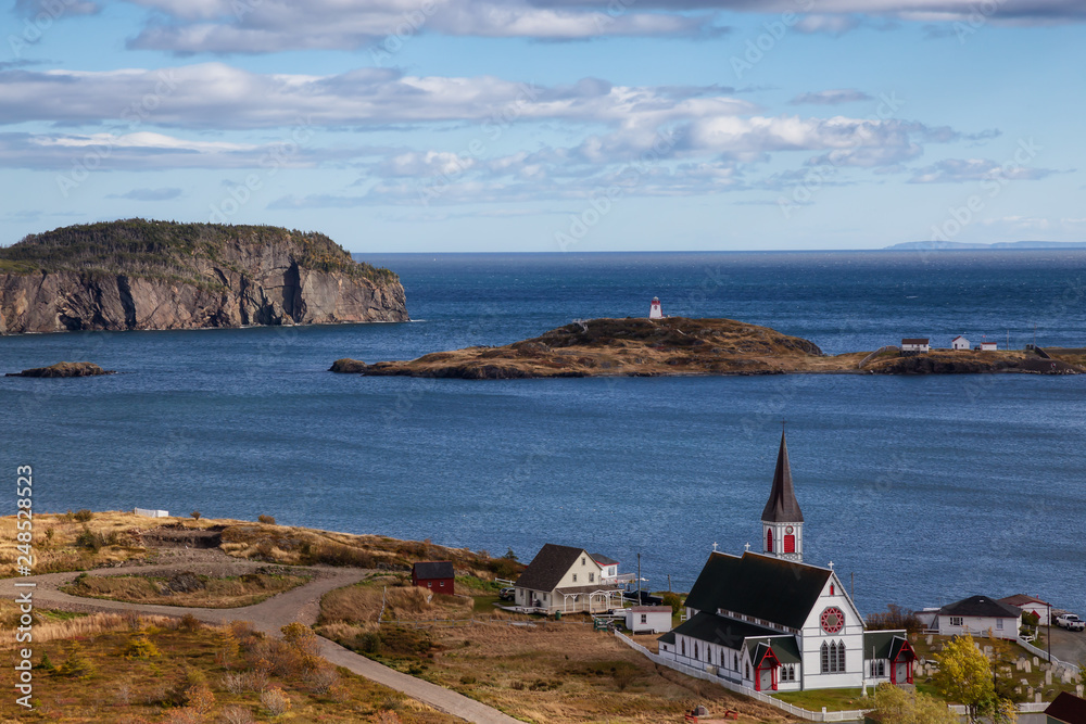 Aerial view of a small town on the Atlantic Ocean Coast during a sunny day. Taken in Trinity, Newfoundland and Labrador, Canada.