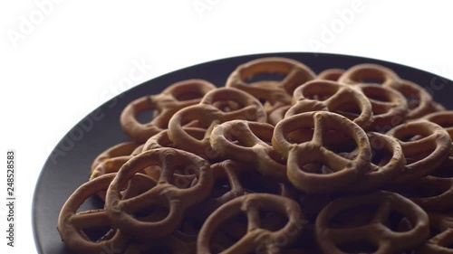 Pretzel salted in rotation. Close up. Studio shot. isolated on white. Unhealthy diet concept. Junk food concept.