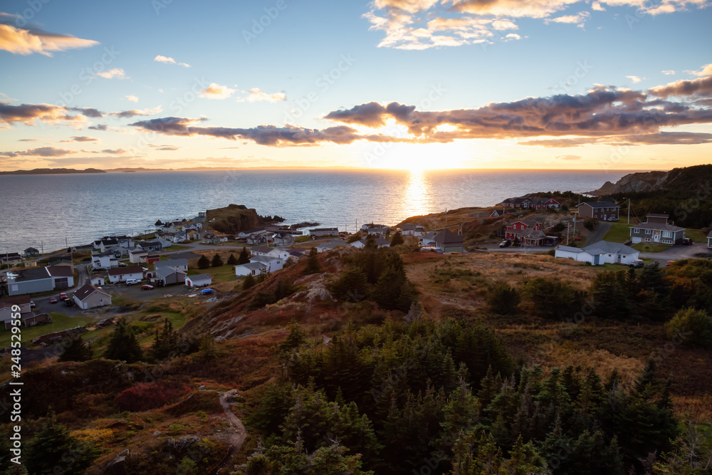 Beautiful view of a small town on the Atlantic Ocean Coast during a vibrant sunset. Taken in Crow Head, North Twillingate Island, Newfoundland and Labrador, Canada.