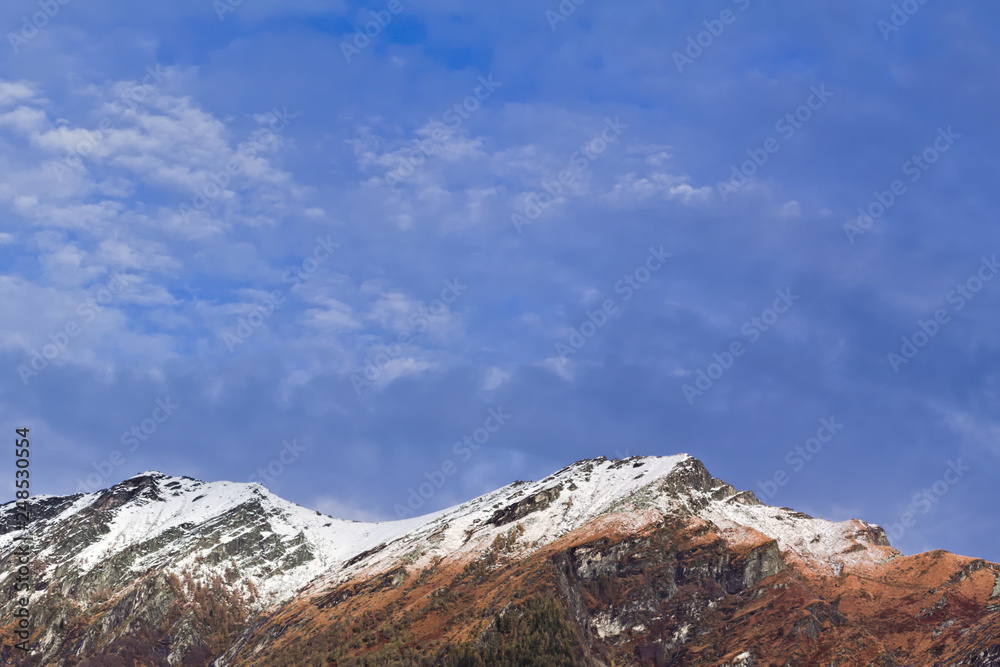 Scenic landscape with snow capped mountain peaks and copy space.