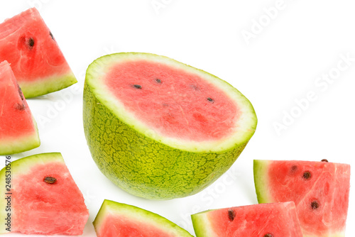 Ripe round watermelon and half a berry isolated on white . Free space for text.