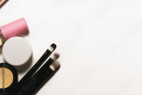 Makeup tools and accessories on a white background with copy space for text. Top view