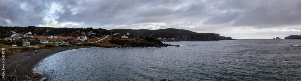 Panoramic view of a small town on the Atlantic Ocean Coast during a cloudy evening. Taken in Little Wild Cove, North Twillingate Island, Newfoundland and Labrador, Canada.