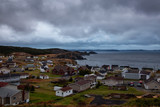 Beautiful view of a small town on the Atlantic Ocean Coast during a cloudy evening. Taken in Crow Head, North Twillingate Island, Newfoundland and Labrador, Canada.
