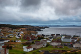 Beautiful view of a small town on the Atlantic Ocean Coast during a cloudy evening. Taken in Crow Head, North Twillingate Island, Newfoundland and Labrador, Canada.