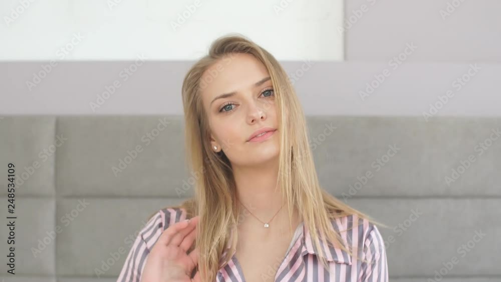 Attractive girl with beautiful blue eyes looking at camera while resting in bedroom. Lifestyle, Beauty concept Attractive girl with beautiful blue eyes looking at camera while resting in bedroom. Lifestyle, Beauty concept