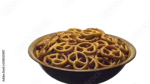 Pretzel salted in rotation. Close up. Studio shot. isolated on white. Unhealthy diet concept. Junk food concept.