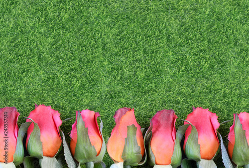 Red silk roses and artificial green grass form a bottom border. Good for the running of the thoroughbred race called the Kentucky Derby. Copy space