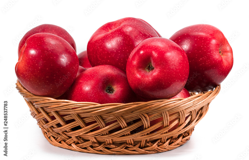Ripe red apple in wicker basket isolated on white Ripe red apple in wicker basket isolated on white