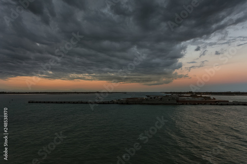 Evening aerial view of Punta Sabbioni and Sant Erasmo island in the Venice lagoon during a thunderstorm