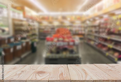 Empty wooden board table top on of blurred supermarket background. with copy space for display or montage your products