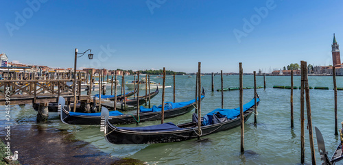 Gondolas moored by Saint Mark square in Venice, Italy at claudy day