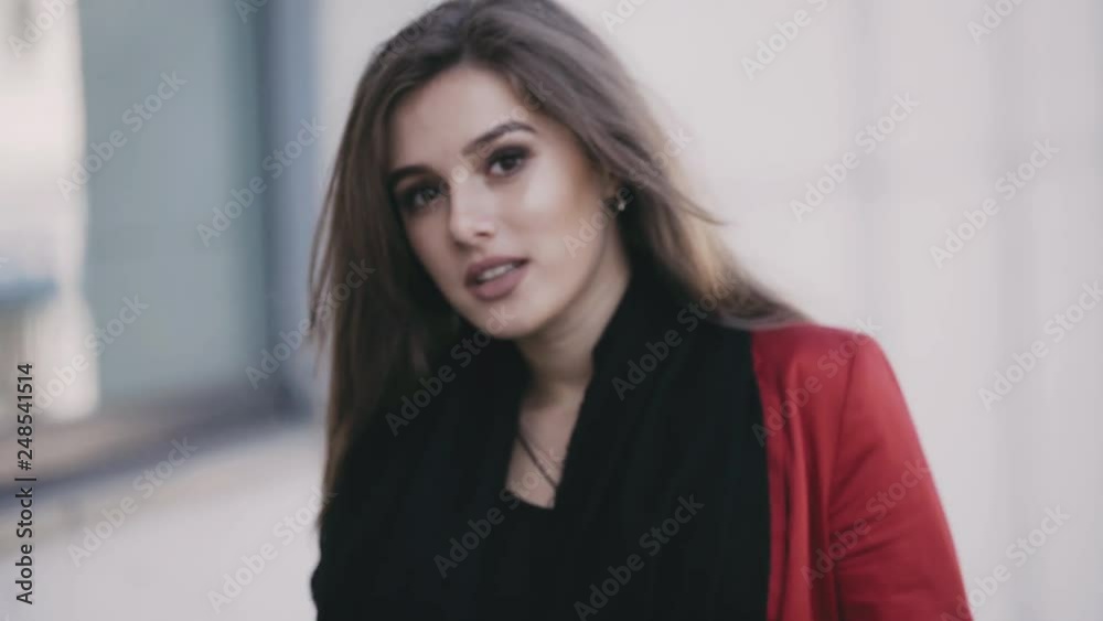 Attractive girl with black scarf, passionately poses at camera and smiles