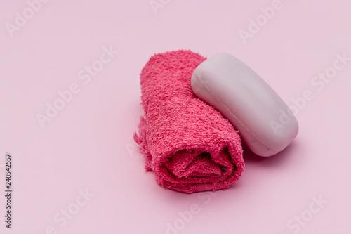towel wrapped with soap, pink background