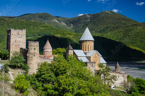 Church of the Mother of God  Ananuri with mountains and blue sky with few clouds above